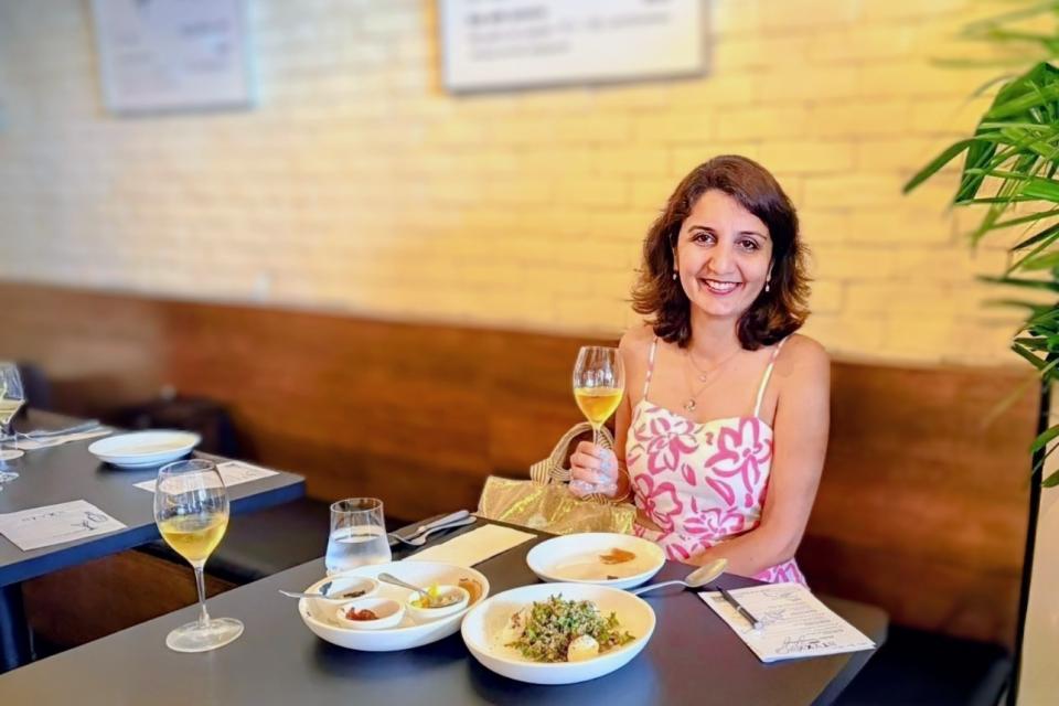 Harnoor Channi-Tiwary Travel writer with Expat choice sitting at a table in Styxx the Singapore restaurant  Styxx